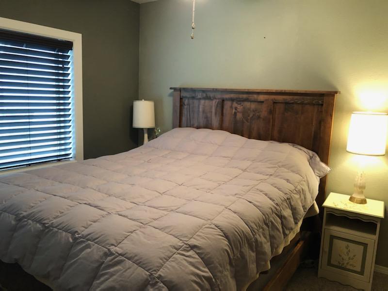 2850 South River Road Grants Pass, OR 97527 - Photo 13 of 26 a large bed sitting in a bedroom next to a lamp