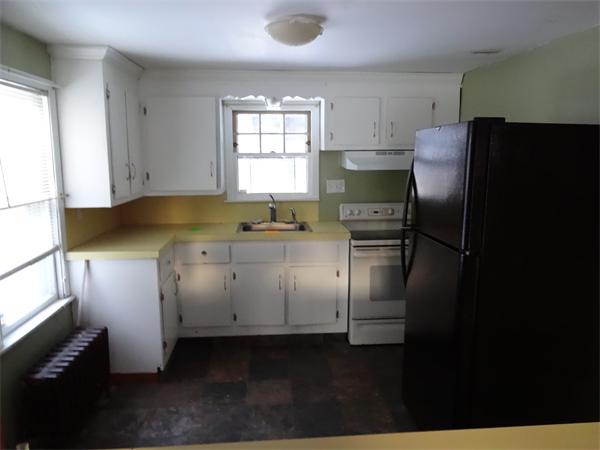 59 Carew Terrace Springfield, MA 01104 - Photo 4 of 11 a kitchen with a sink a refrigerator and window