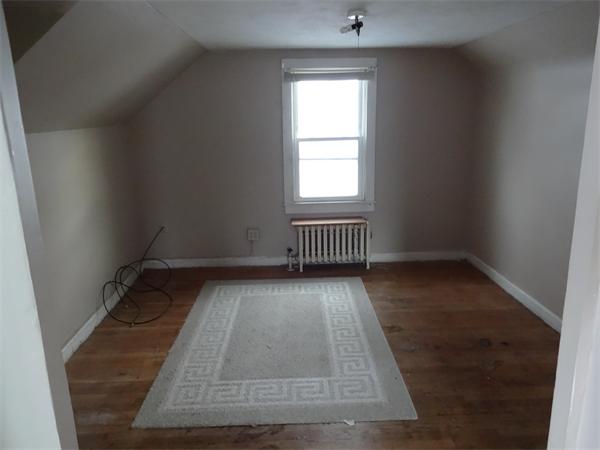 59 Carew Terrace Springfield, MA 01104 - Photo 8 of 11 an empty room with wooden floor and windows
