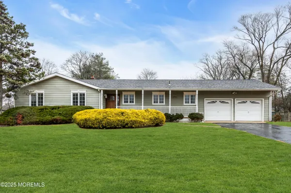 a front view of a house with a yard and porch