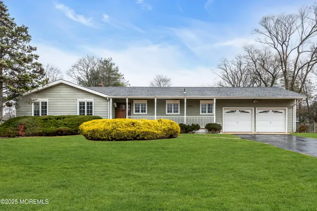 a front view of a house with a yard and porch