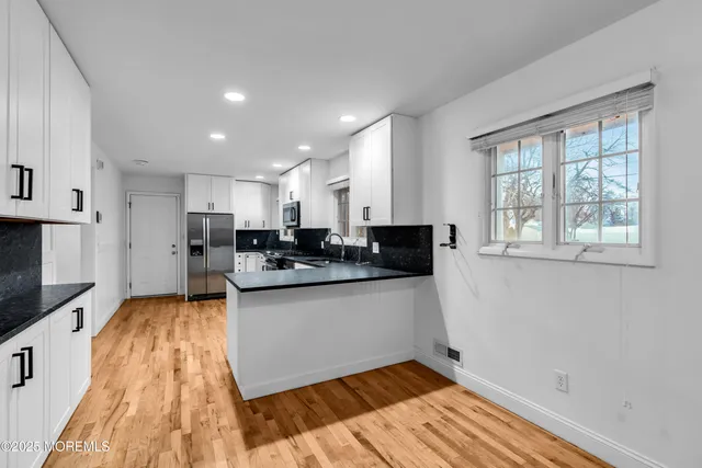 a kitchen with stainless steel appliances granite countertop a sink and cabinets