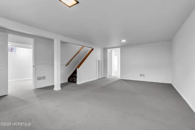 a view of an empty room with stairs