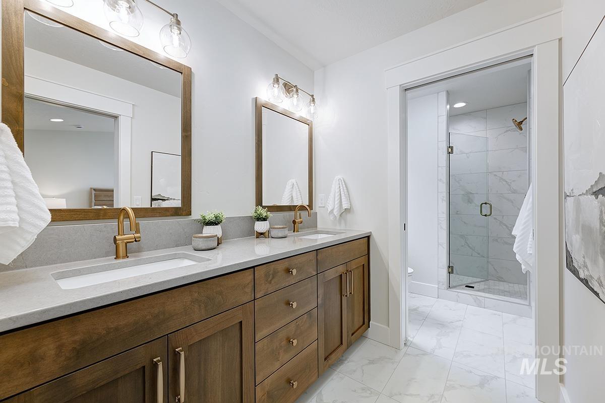 6975 South Skybreak Lane Meridian, ID 83642 - Photo 12 of 29 Full bath featuring light marble finish flooring, a stall shower, double vanity, and recessed lighting