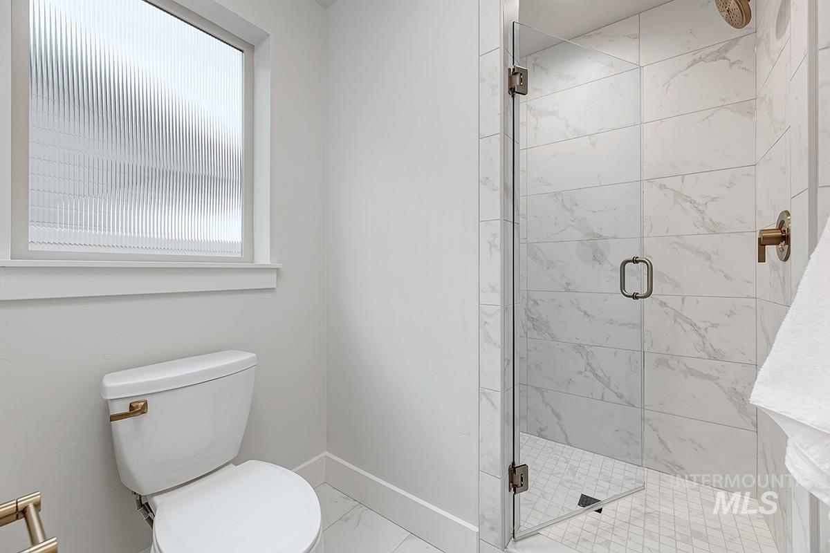 6975 South Skybreak Lane Meridian, ID 83642 - Photo 13 of 29 Full bath featuring a stall shower and light marble finish flooring