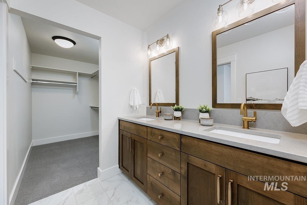 6975 South Skybreak Lane Meridian, ID 83642 - Photo 14 of 29 Full bath with a spacious closet, double vanity, and light marble finish flooring