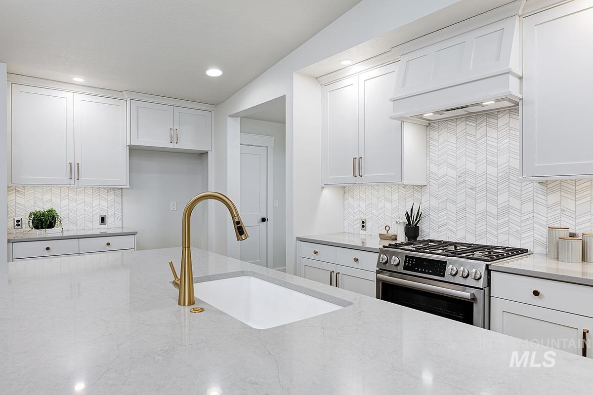 6975 South Skybreak Lane Meridian, ID 83642 - Photo 5 of 29 Kitchen with stainless steel gas range oven, white cabinets, and recessed lighting