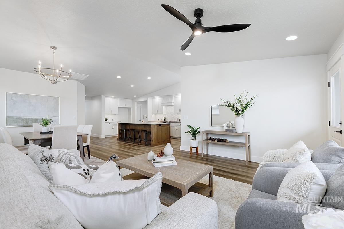 6975 South Skybreak Lane Meridian, ID 83642 - Photo 9 of 29 Living area with light wood-type flooring, ceiling fan, a chandelier, and vaulted ceiling