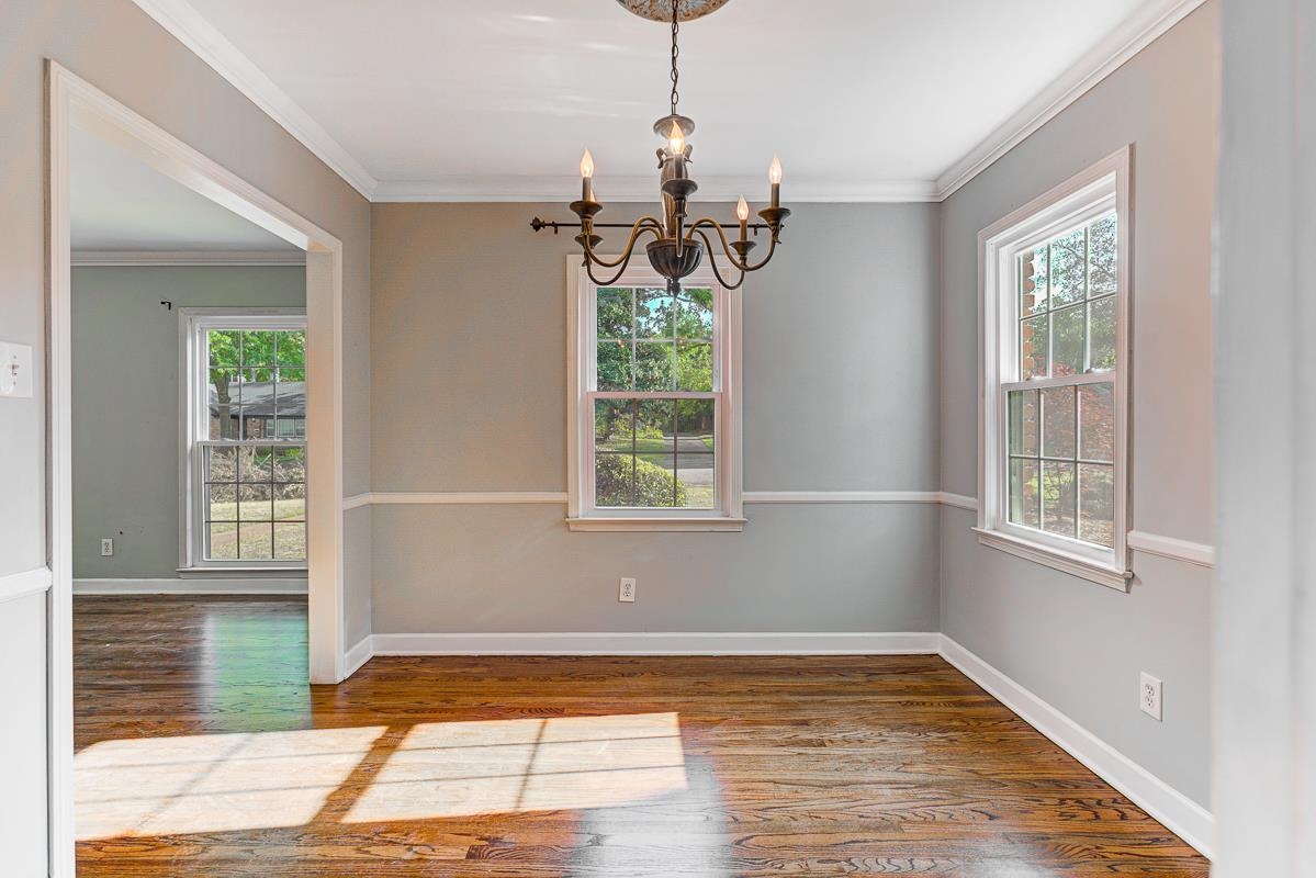 5676 Barfield Road Memphis, TN 38120 - Photo 6 of 19 Dining Room with wood-finish flooring, two large windows, white crown molding, and wainscoting, beautiful light!