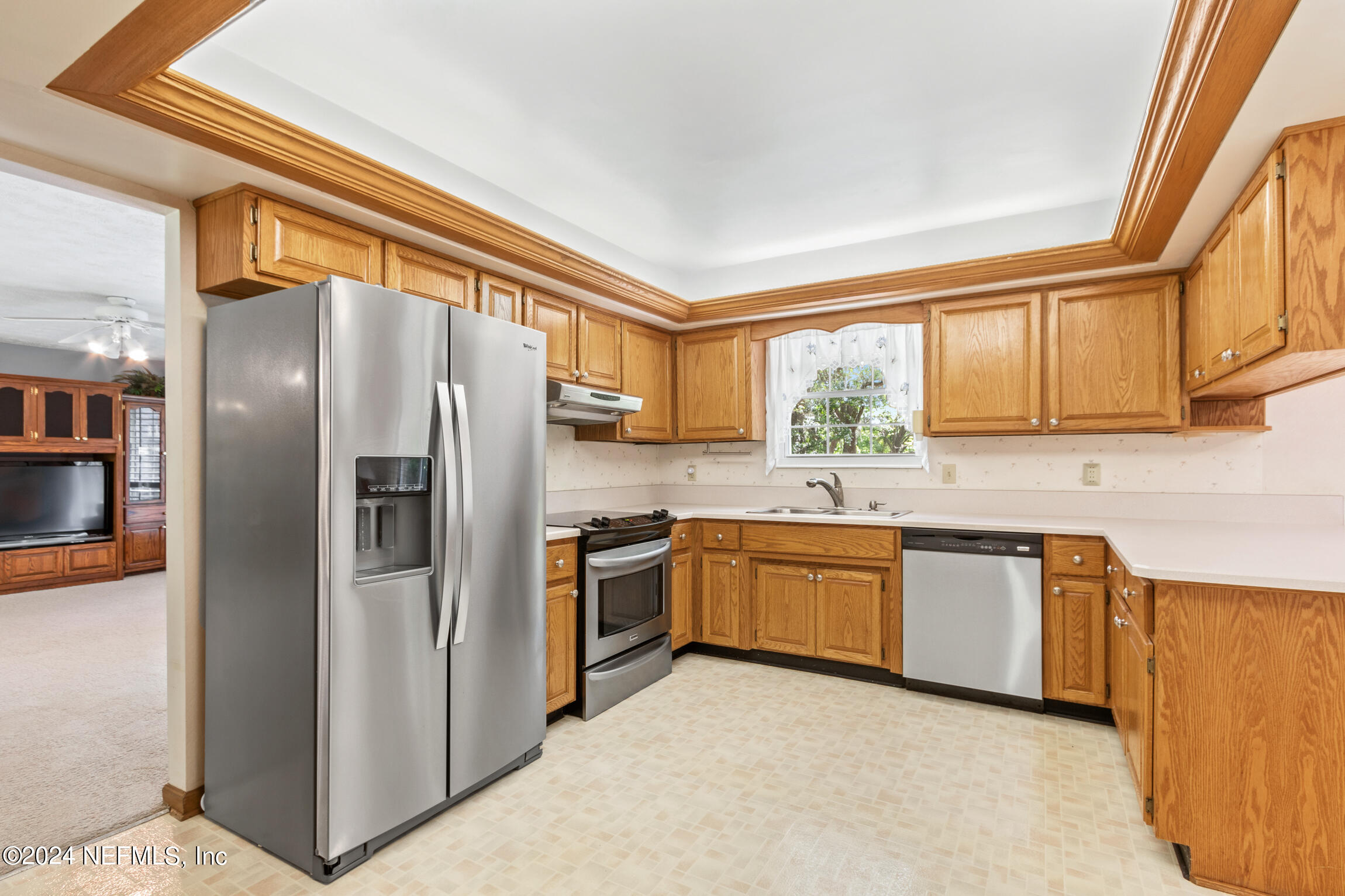 3153 Tiger Hole Road Jacksonville, FL 32216 - Photo 19 of 68 a kitchen with stainless steel appliances granite countertop a refrigerator and a stove top oven