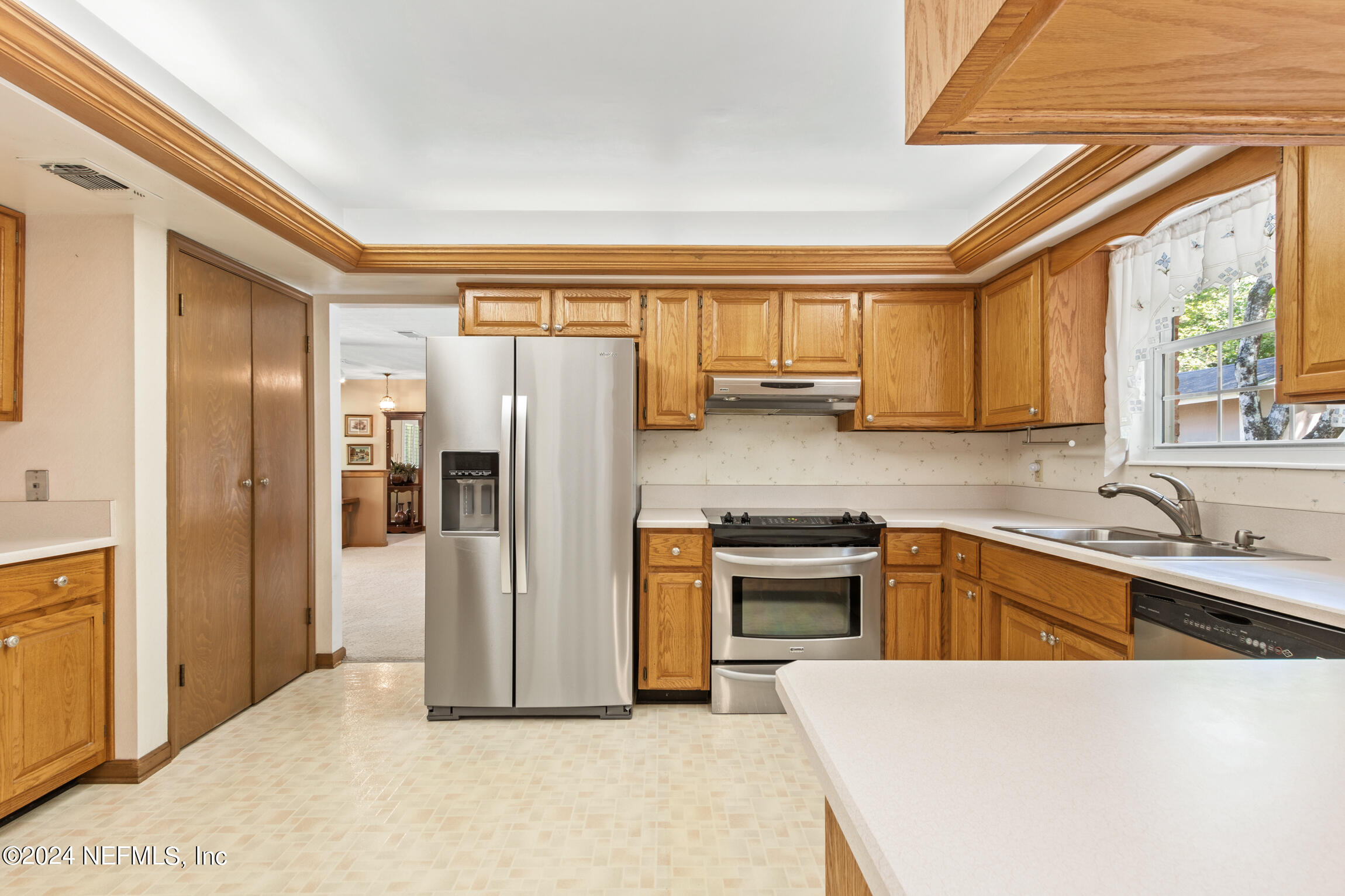 3153 Tiger Hole Road Jacksonville, FL 32216 - Photo 20 of 68 a kitchen with stainless steel appliances granite countertop a refrigerator and a sink
