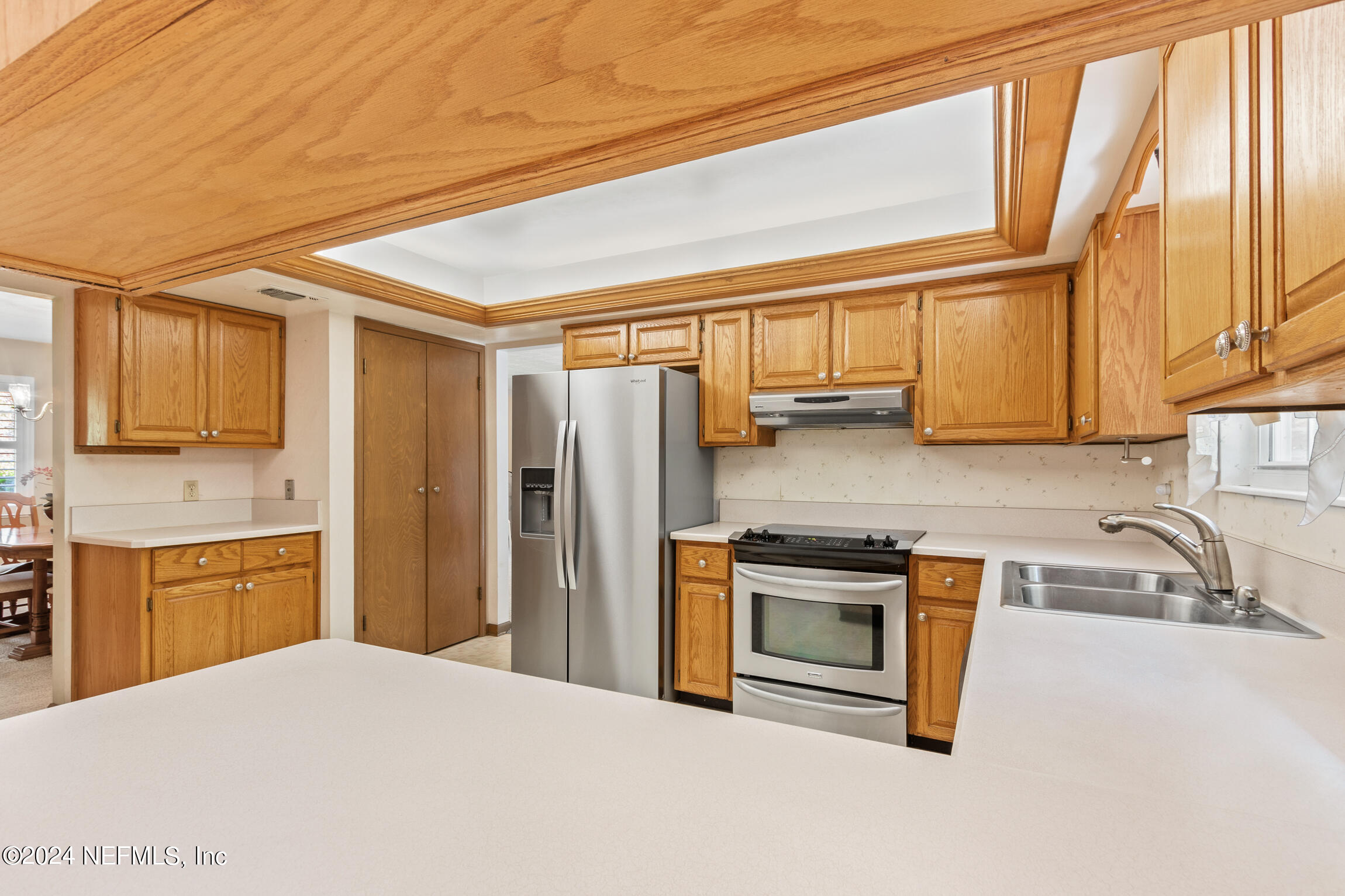 3153 Tiger Hole Road Jacksonville, FL 32216 - Photo 21 of 68 a kitchen with stainless steel appliances granite countertop a refrigerator a stove a sink and dishwasher