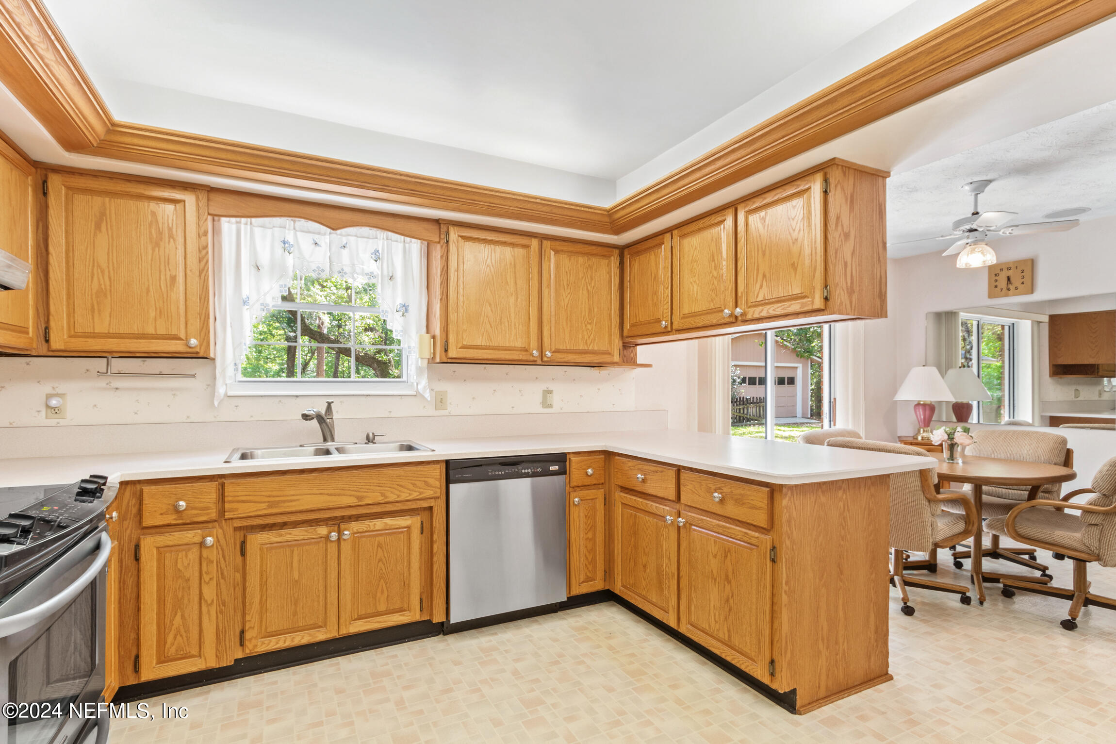 3153 Tiger Hole Road Jacksonville, FL 32216 - Photo 22 of 68 a kitchen with a sink stove and cabinets