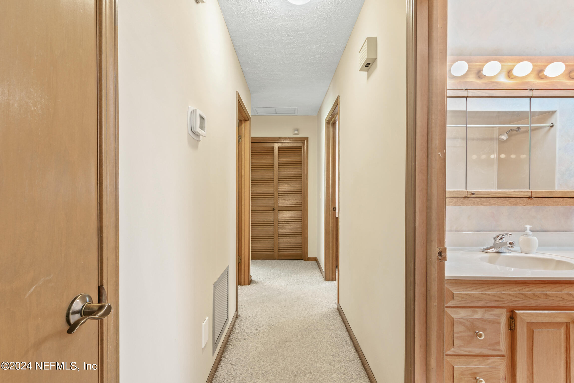3153 Tiger Hole Road Jacksonville, FL 32216 - Photo 26 of 68 a view of a bathroom from a hallway
