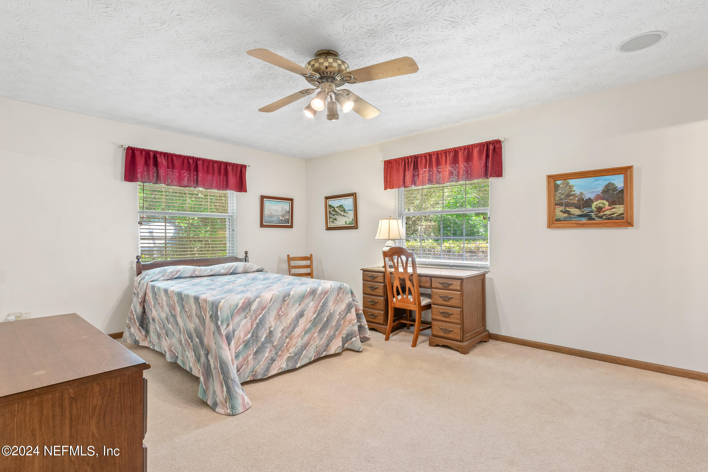 3153 Tiger Hole Road Jacksonville, FL 32216 - Photo 29 of 68 a bedroom with a bed and a chandelier
