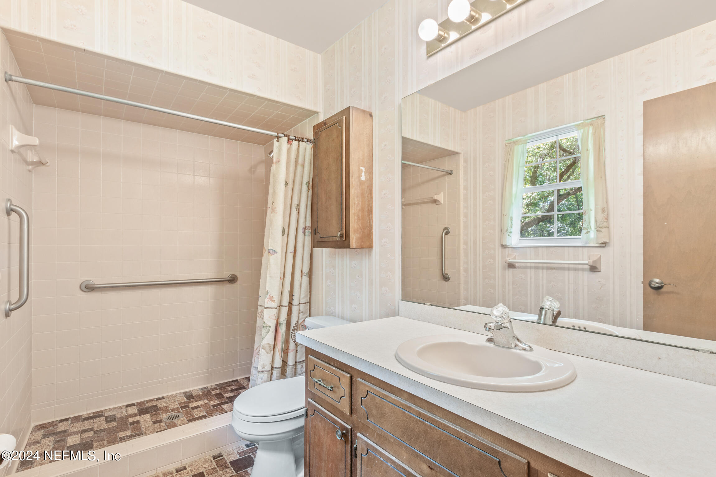 3153 Tiger Hole Road Jacksonville, FL 32216 - Photo 31 of 68 a bathroom with a sink toilet and shower