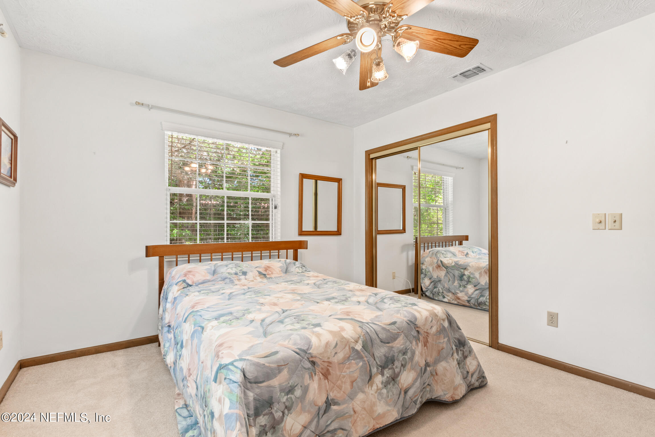 3153 Tiger Hole Road Jacksonville, FL 32216 - Photo 34 of 68 a large bed sitting in a bedroom next to a window