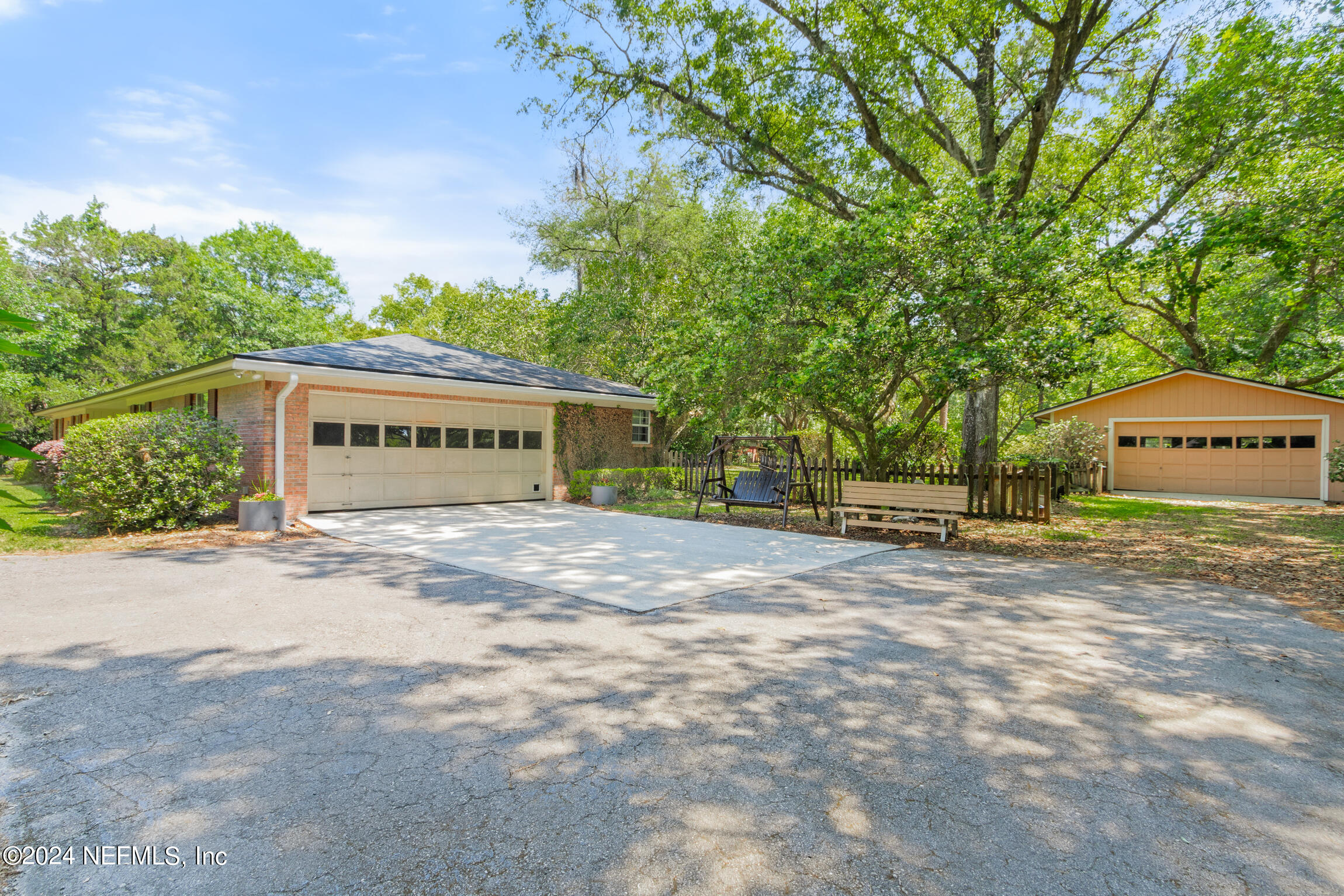3153 Tiger Hole Road Jacksonville, FL 32216 - Photo 35 of 68 a front view of a house with a yard and garage