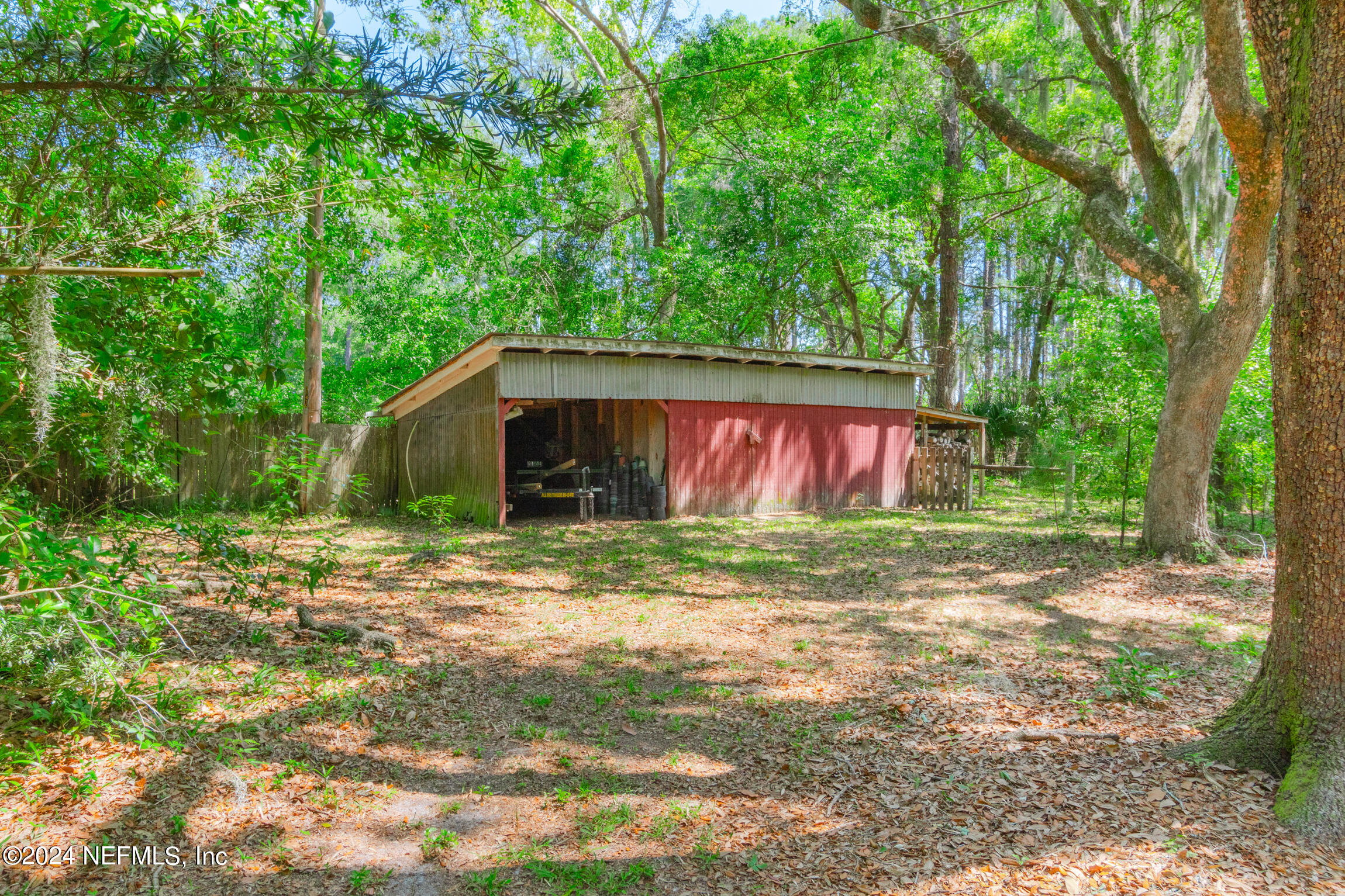 3153 Tiger Hole Road Jacksonville, FL 32216 - Photo 46 of 68 a view of a barn in the middle of a yard
