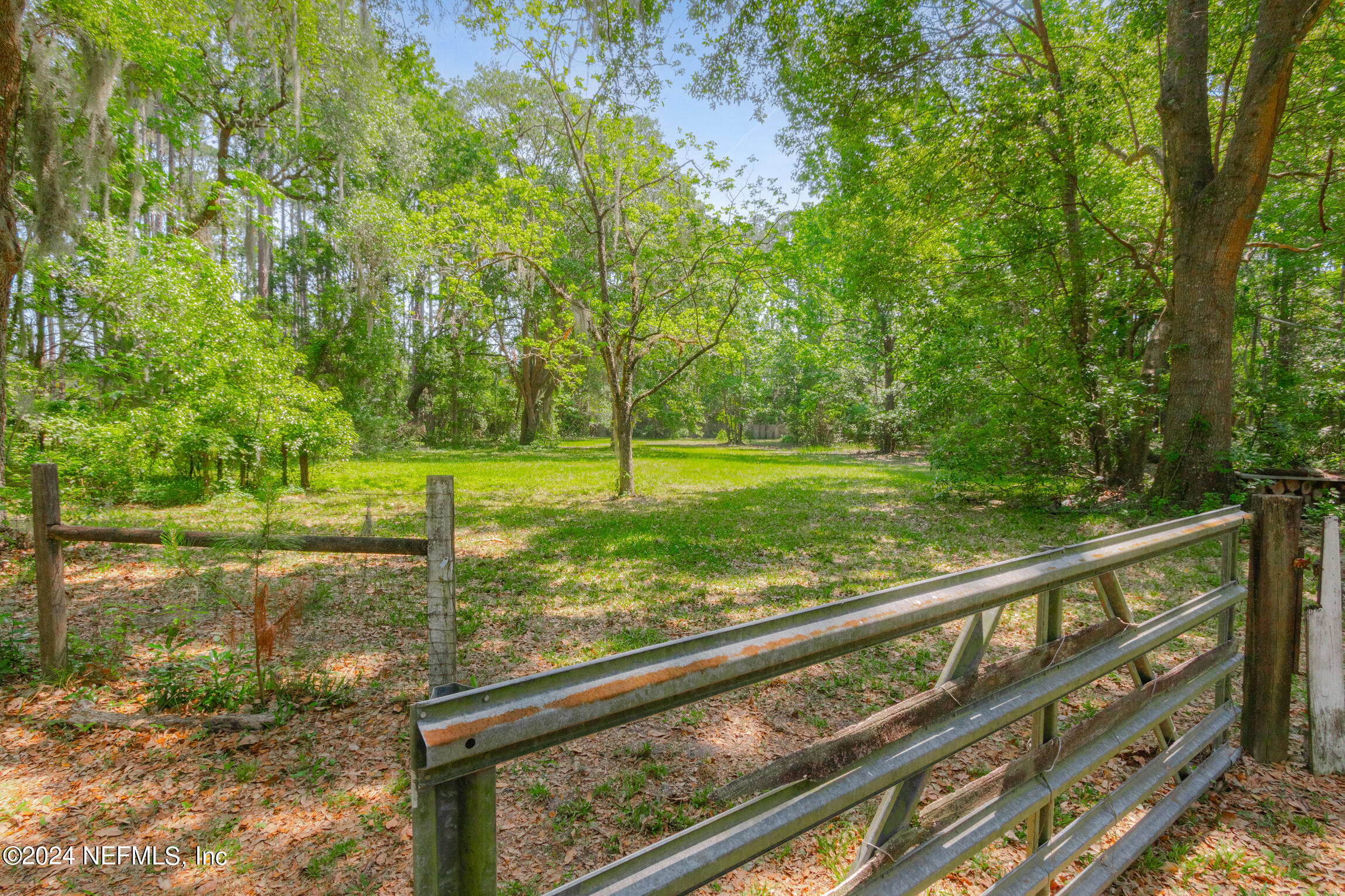 3153 Tiger Hole Road Jacksonville, FL 32216 - Photo 47 of 68 a view of a yard with wooden fence
