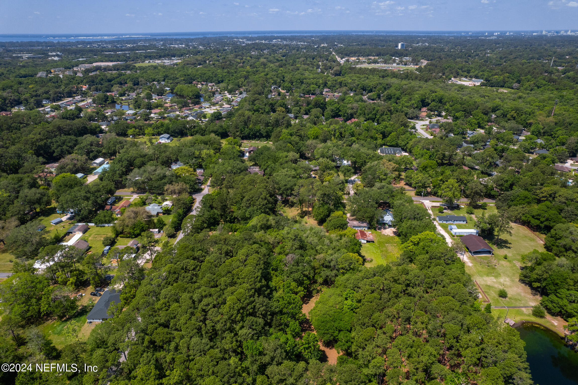 3153 Tiger Hole Road Jacksonville, FL 32216 - Photo 53 of 68 an aerial view of a houses with a lush green hillside