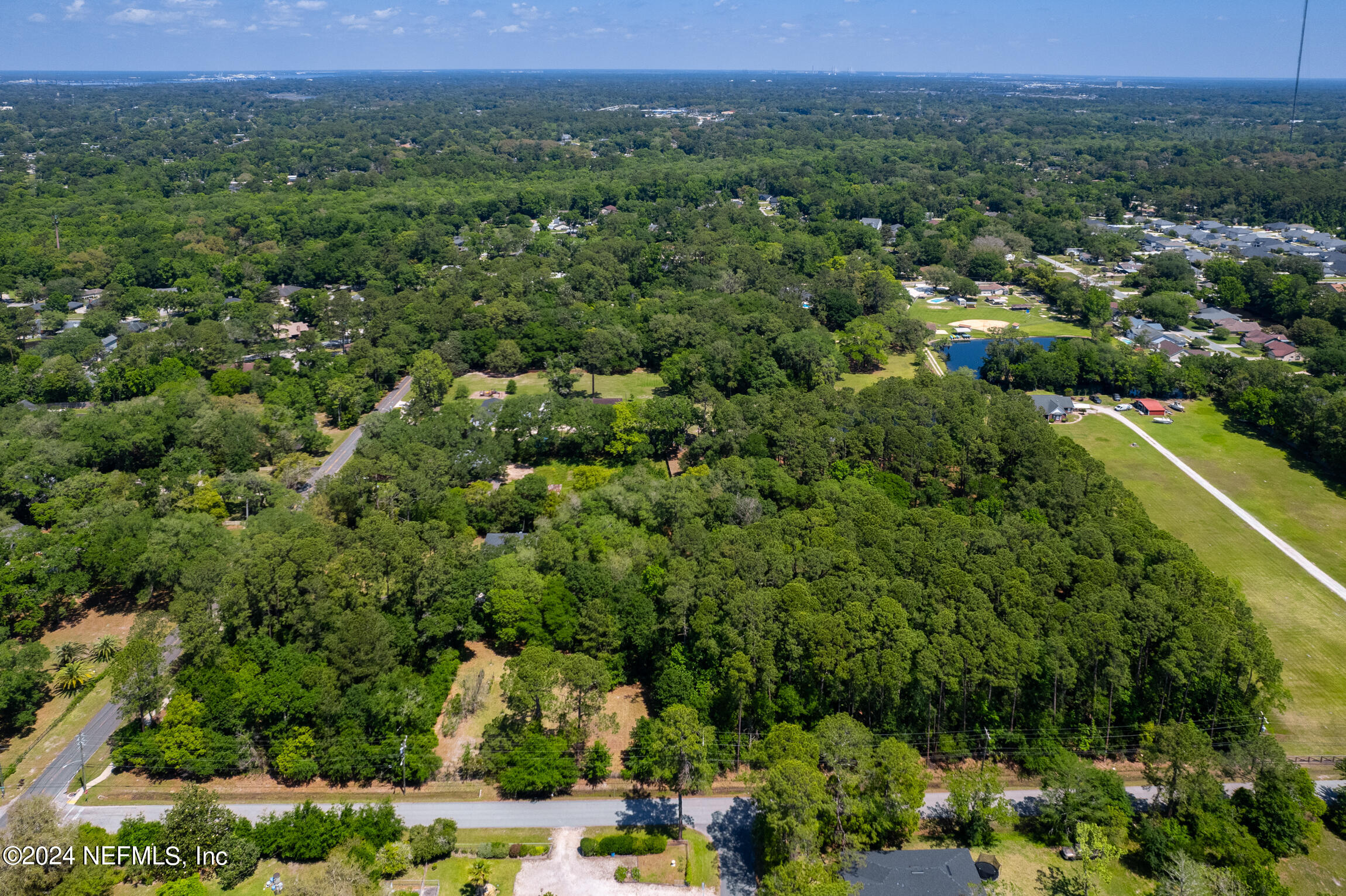 3153 Tiger Hole Road Jacksonville, FL 32216 - Photo 59 of 68 an aerial view of a houses with a yard and lake view