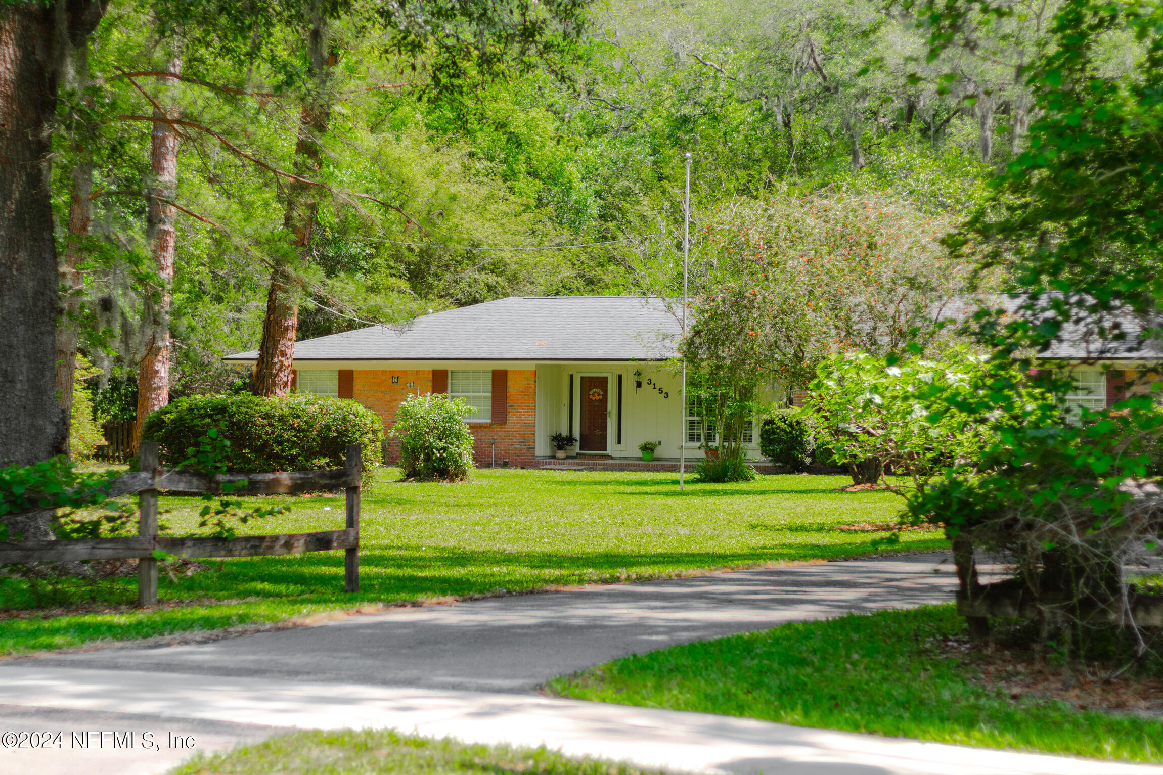 3153 Tiger Hole Road Jacksonville, FL 32216 - Photo 5 of 68 a front view of a house with a yard