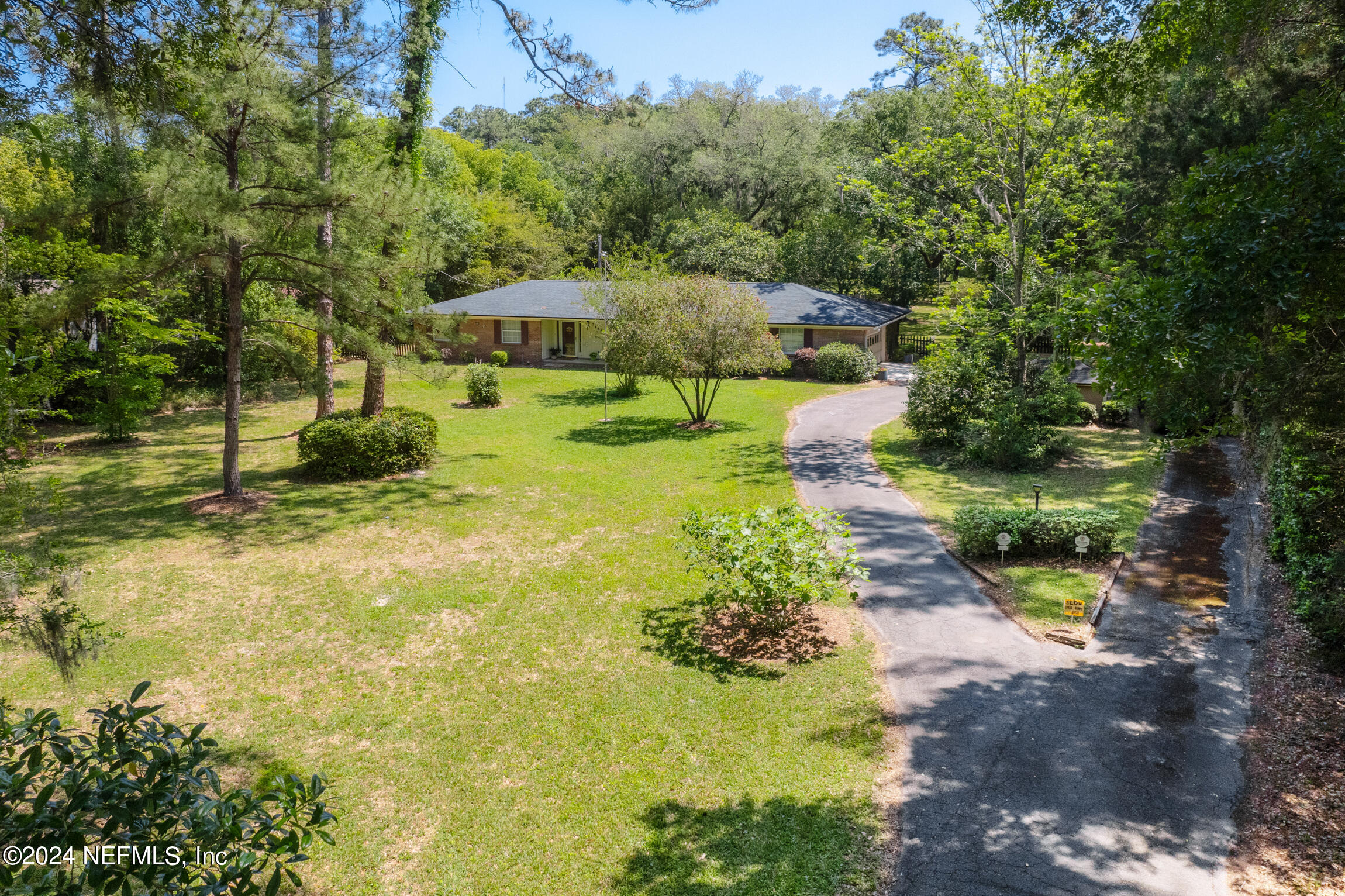 3153 Tiger Hole Road Jacksonville, FL 32216 - Photo 6 of 68 a view of a garden with large trees