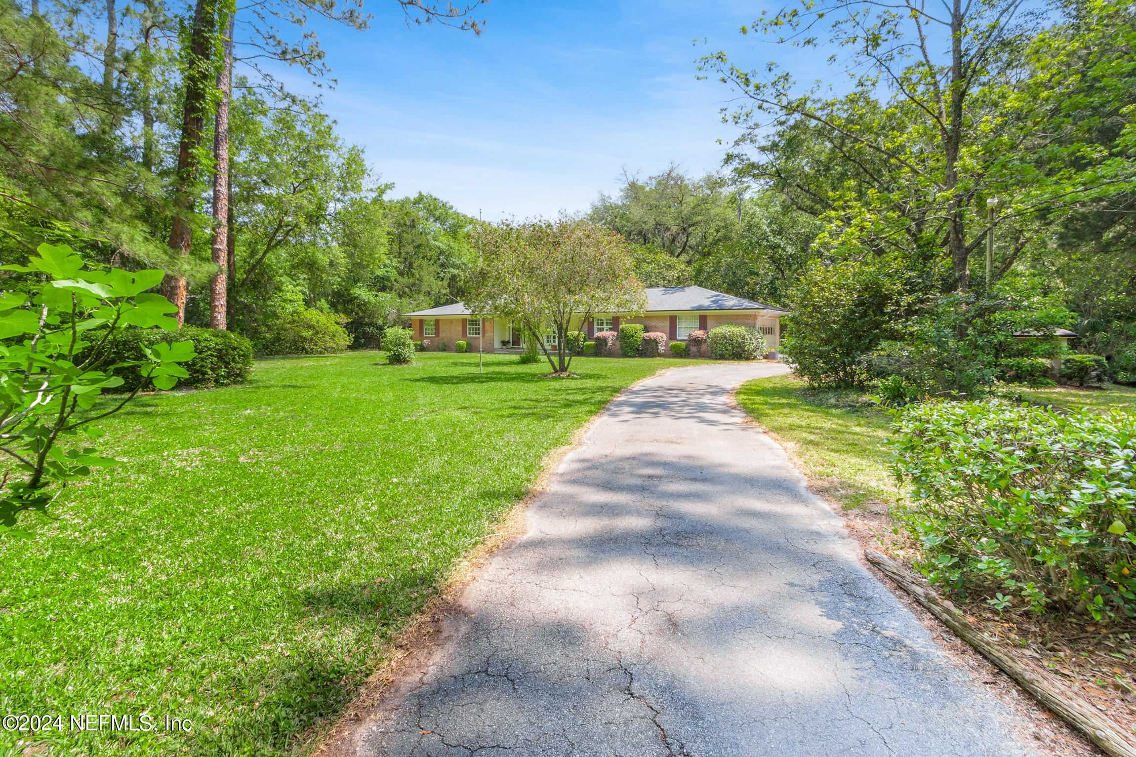 3153 Tiger Hole Road Jacksonville, FL 32216 - Photo 7 of 68 a front view of a house with yard and green space