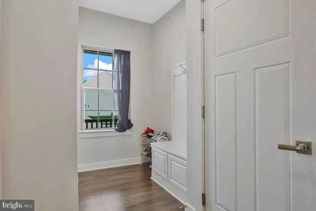 a view of an entryway with wooden floor
