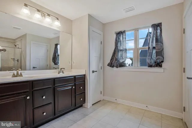 a bathroom with a double vanity sink and mirror