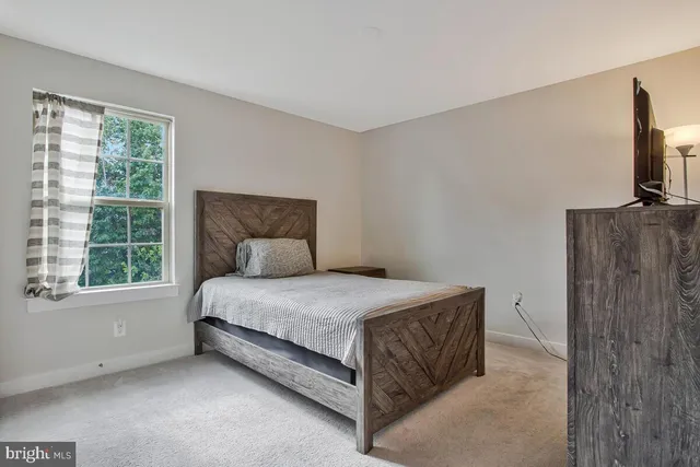 a bed sitting in a room next to a window