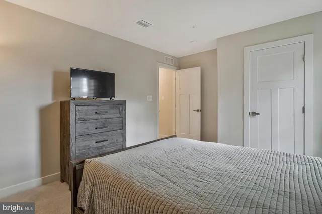 a bedroom with a bed and flat screen tv