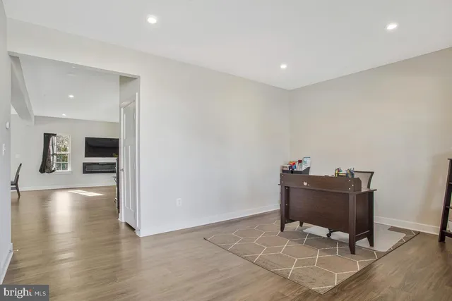 a view of a workspace with furniture and wooden floor