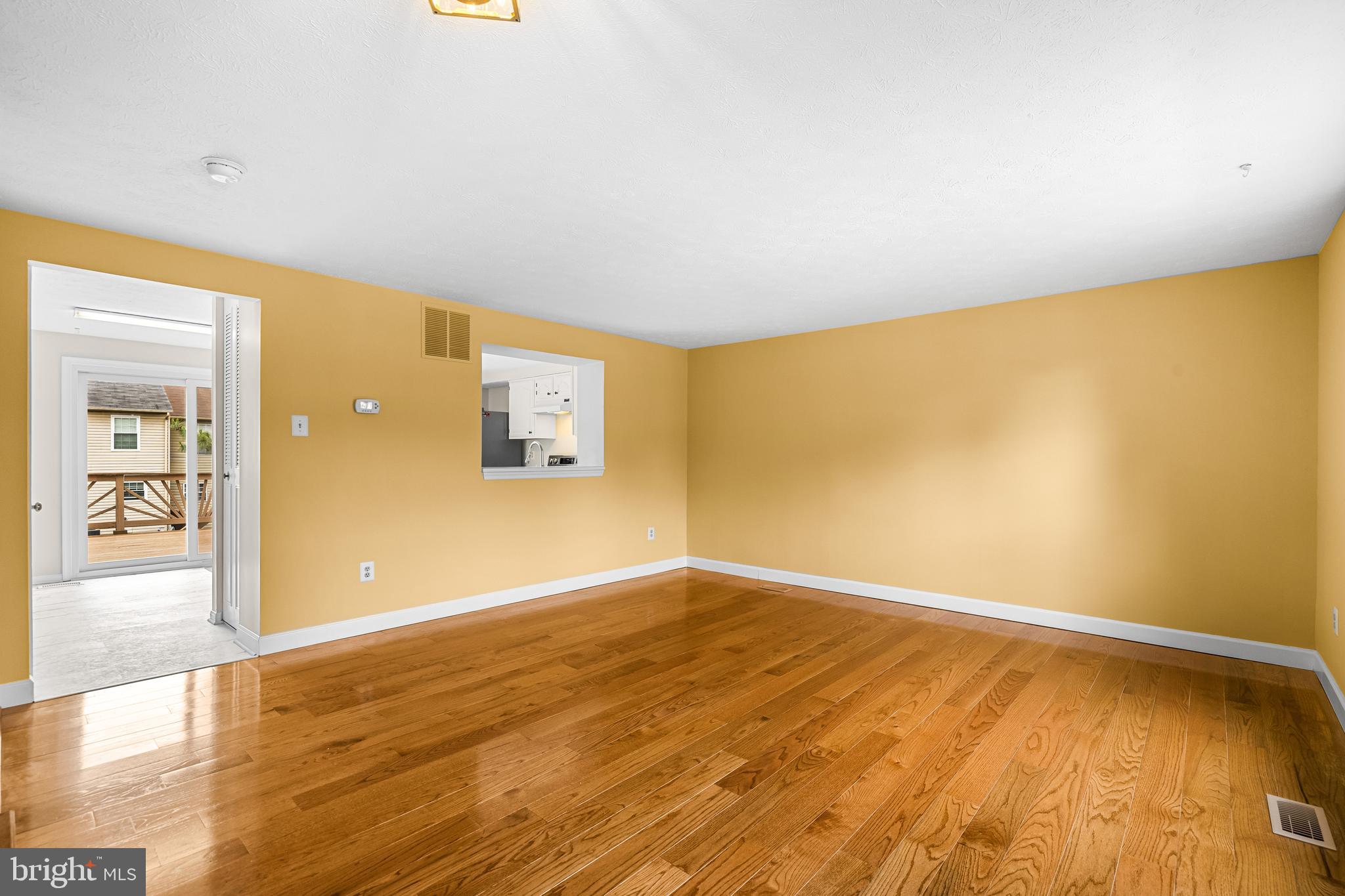 3790 Timahoe Circle Baltimore, MD 21236 - Photo 3 of 33 an empty room with wooden floor and windows