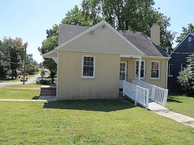 a view of a house with a yard and a garden