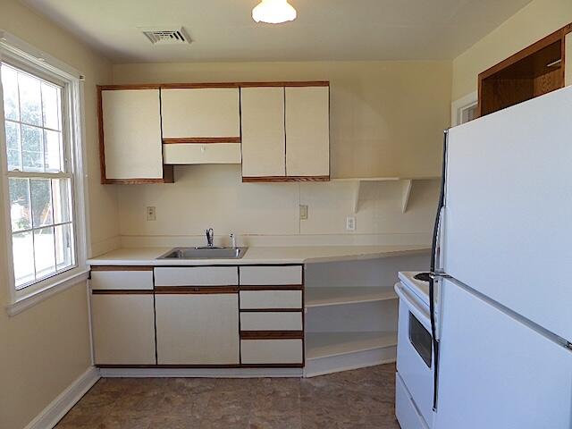 429 Fieldale Road Northeast Roanoke, VA 24012 - Photo 14 of 24 a kitchen with a cabinets and window