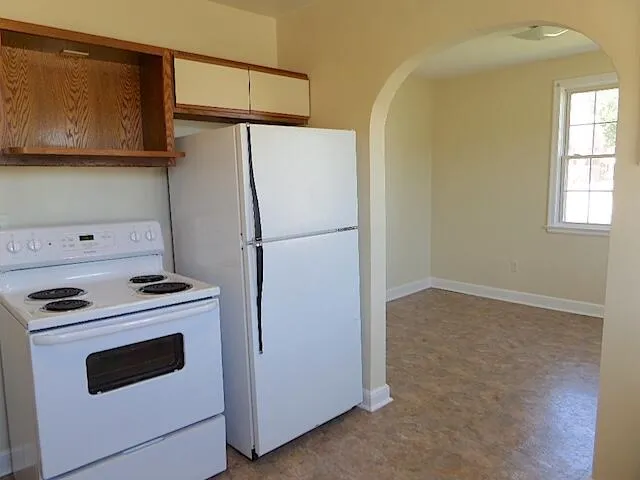 a kitchen with a refrigerator stove and microwave