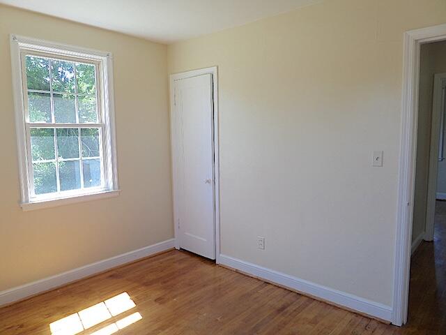 429 Fieldale Road Northeast Roanoke, VA 24012 - Photo 19 of 24 an empty room with wooden floor and windows