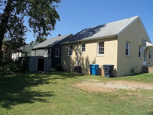 a view of a house with yard and a garage