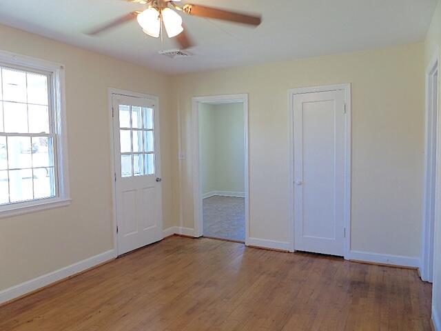 429 Fieldale Road Northeast Roanoke, VA 24012 - Photo 5 of 23 an empty room with wooden floor chandelier and windows