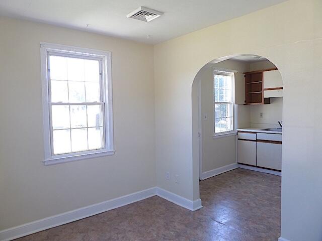 429 Fieldale Road Northeast Roanoke, VA 24012 - Photo 7 of 23 an empty room with windows and cabinet