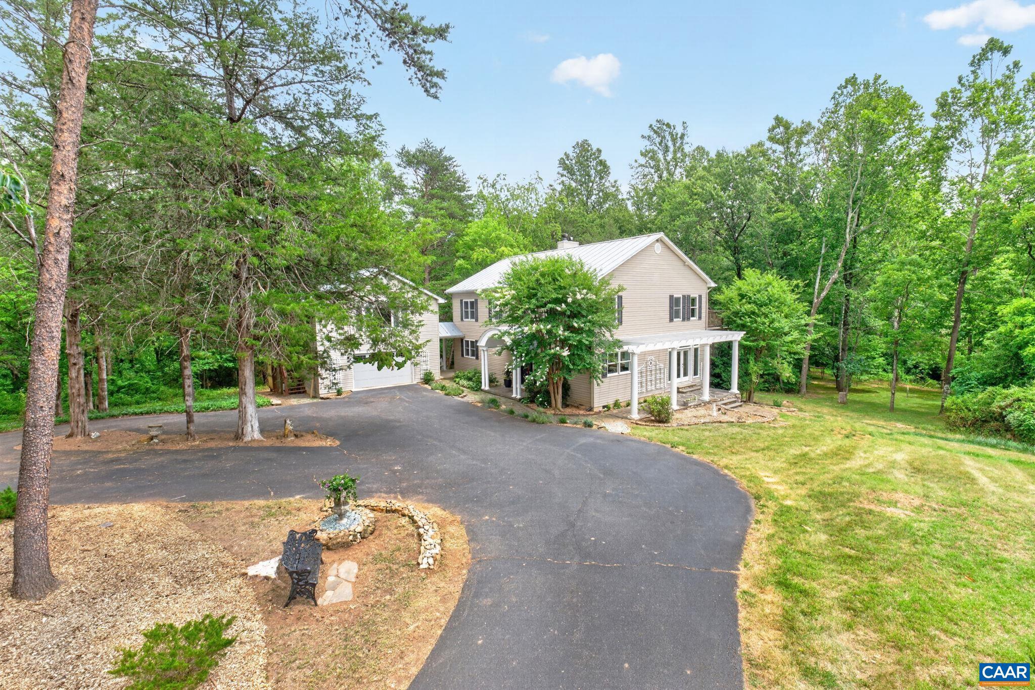 6285 Jarmans Gap Road Crozet, VA 22932 - Photo 60 of 65 a front view of a house with a yard and trees