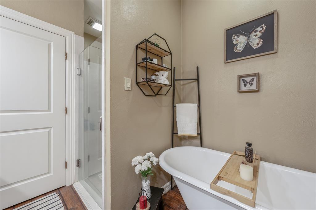 13043 County Road 4182 Henderson, TX 75654 - Photo 19 of 40 a bathroom with a granite countertop sink a toilet and a shower
