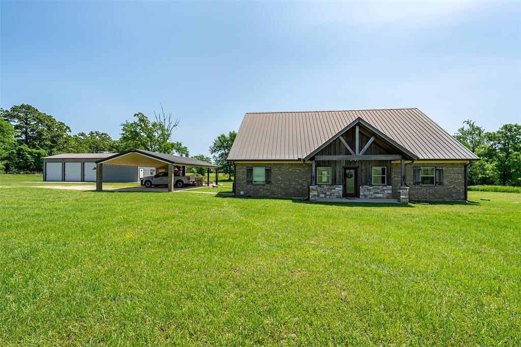 13043 County Road 4182 Henderson, TX 75654 - Photo 2 of 40 a front view of a house with a yard