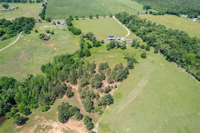 an aerial view of a house with a yard