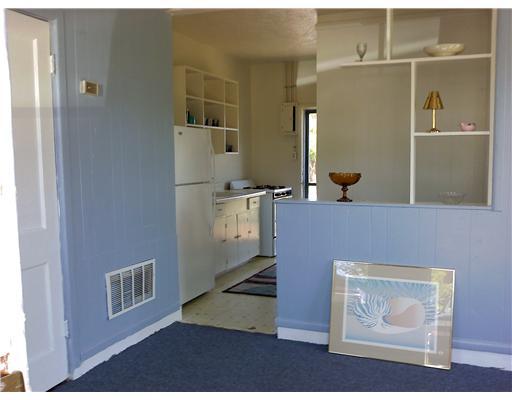 1117 Barton Street Corpus Christi, TX 78418 - Photo 2 of 4 a view of an empty room with wooden floor and cabinet