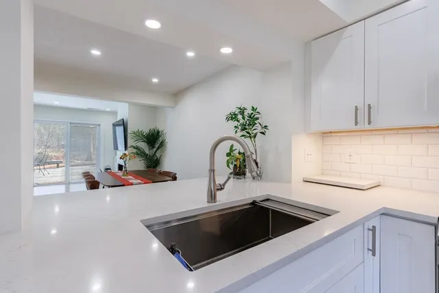 a kitchen that has a sink and a stove