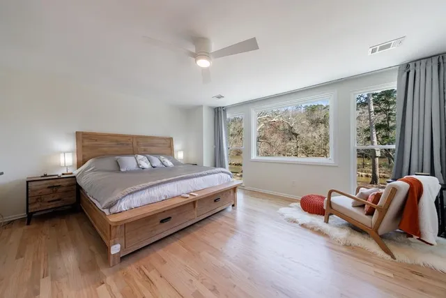 a bedroom with a bed and wooden floor