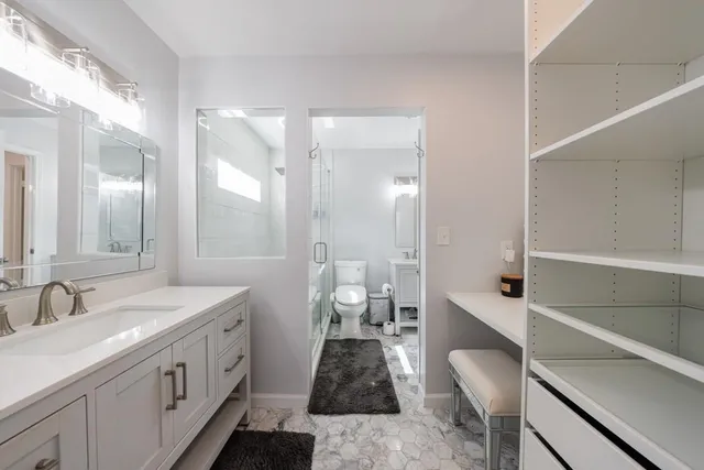 a spacious bathroom with a double vanity sink and a mirror